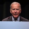 Man at podium looks straight ahead