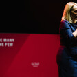 A woman in a dress speaking into a microphone