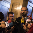 Man surrounded by microphones 