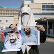Woman wearing a veil holds two portraits of a man