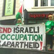 Four women hold a banner reading "End Israeli occupation and apartheid!"