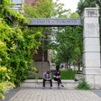 Two people sit on a bench