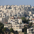 Densely-packed apartment buildings fill a landscape