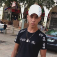 Boy stands in the street wearing cap 