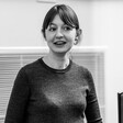 Woman in crewneck and bangs in black and white picture 