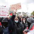 Many people march holding signs