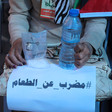 Hands holding water battle, clear bag with white powder and a sign 