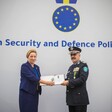 Woman stands beside man wearing a police uniform 