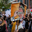 A group of protesters hold signs