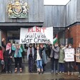 Protesters with signs outside a court