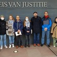 People stand together in front of modern building