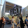 People walk around an exhibition structure 