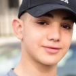 A teenager wearing a baseball cap