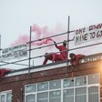 Activists on a rooftop smash windows