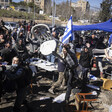 Men throw chairs in a crowd