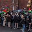 A crowd of protesters with flags