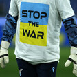 Man's torso wearing a shirt with the Ukrainian flag that reads "stop the war"