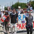 People march and carry signs