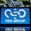 A tablet displays the NSO Group logo