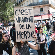 Large crowd holding signs and marching