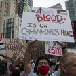 Protesters hold signs