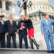 Six members of Congress stand on the House steps of the US Capitol Building