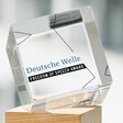 A glass and wood object with words Deutsche Welle Freedom of Speech Award engraved on it