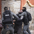 Two police officers attack a young man 