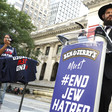 Man stands at podium that says on it Ben and Jerry's must end Jew hatred