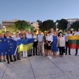 A group of people holds flags of EU and Ukraine and other countries 
