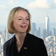 Liz Truss smiles on the backdrop of the New York skyline