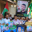 People hold posters, banners and flags 