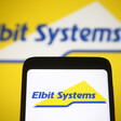 The words Elbit Systems on both a mobile phone and a larger screen