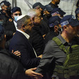 Two politicians walk alongside Israeli police officers