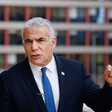 Prominent Israeli politician Yair Lapid wearing a dark suit and blue tie 