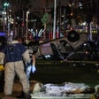 Men in hazmat suits stand near overturned sedan in nighttime scene