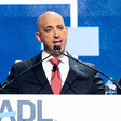 Jonathan Greenblatt of the ADL gesticulates from behind a podium at an ADL event