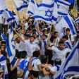 Young men wave Israeli flags