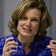 Shot of a woman from shoulders up gesticulating and speaking