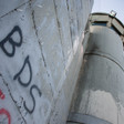 "BDS" written using spray paint on the separation wall 