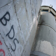 "BDS" written using spray paint on the separation wall