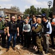 European Commission President Ursula von der Leyen wears a flak jackets while she talks to representatives of Israel's military 