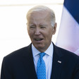 President Joe Biden with a flag behind him