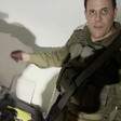 Screenshot of Israeli military spokesperson gesturing to pile behind an MRI machine