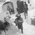 Black and white still of armed soldiers in an office aBlack and white still of armed soldiers in an office 