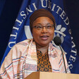 Alice Wairimu Nderitu stands at a podium with logo of U.S. Institute of Peace behind her