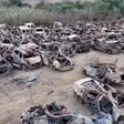 Destroyed cars in a field