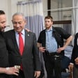 Benjamin Netanyahu and Brian Mast meet with an injured Israeli soldier at a hospital as an additional person looks on