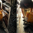 A collage of two images that appear to be taken in the same setting showing an Israeli soldier leaning over a yellow bag in the back of a tank