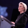 European Commission President Ursula von der Leyen stands at a podium